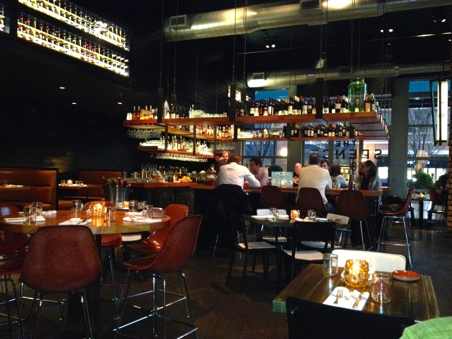 The trendy tables around the trendy bar.