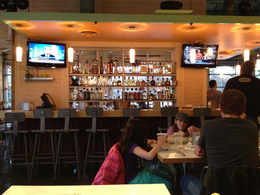 A large bar is the centerpiece of the room.