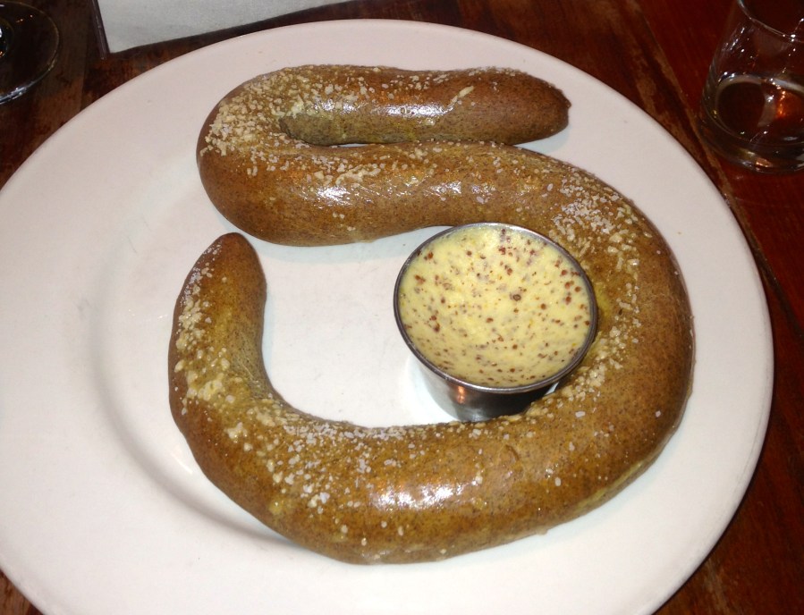 Pretzel with cheesy mustard dip.